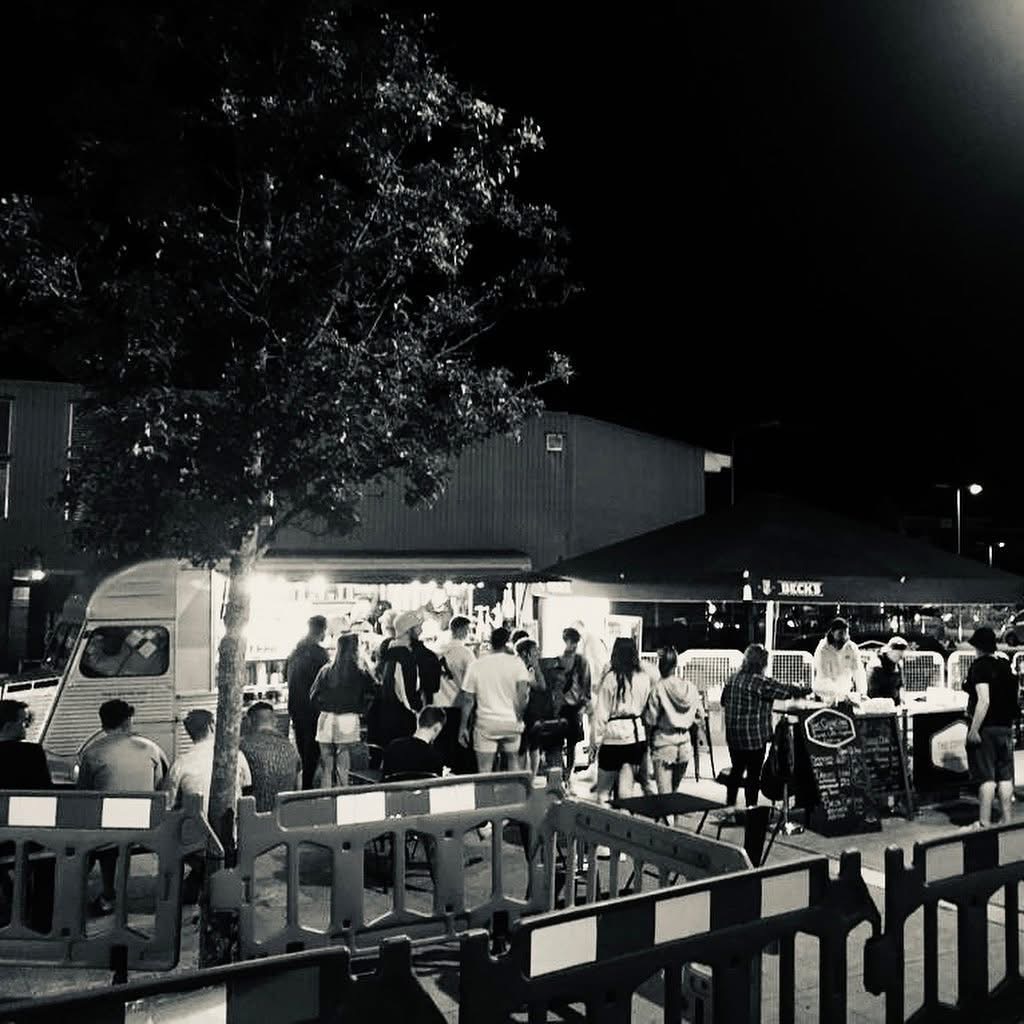 Evening event with crowds queuing at the coffee van